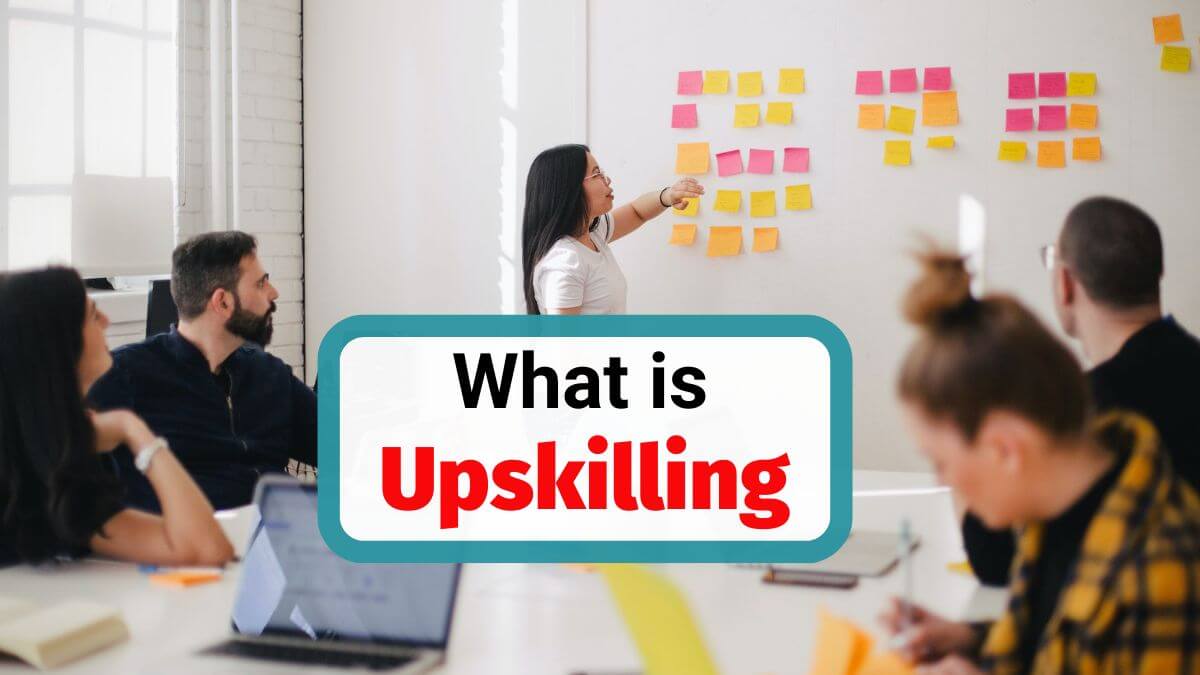 Team meeting with manager presenting sticky notes on a board during an upskilling workshop in the workplace