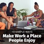 Employees talking together in a relaxed meeting, illustrating a positive work environment.